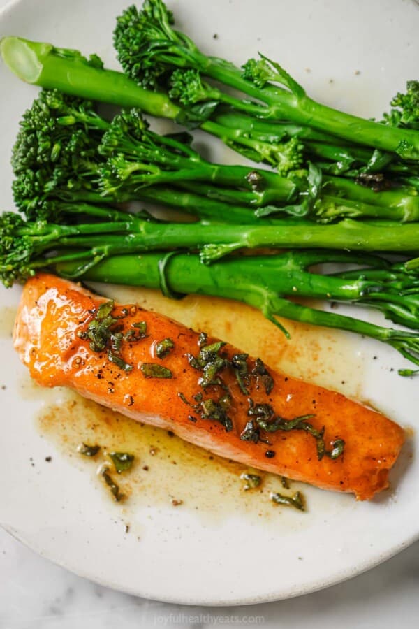 Pan seared salmon with broccolini and brown ،er sauce.