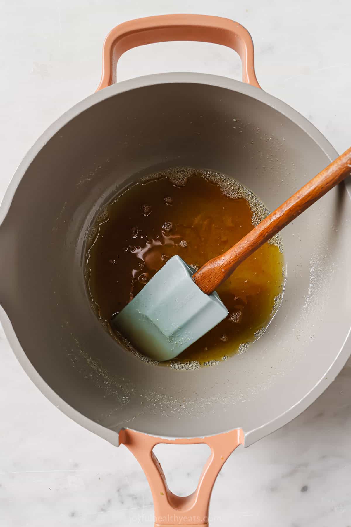 Stirring the browned butter in the pan.