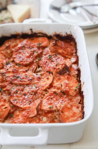 Scalloped sweet potatoes in a casserole dish.