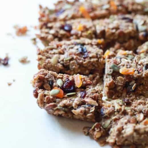 A close-up shot of homemade granola bars arranged on a white countertop