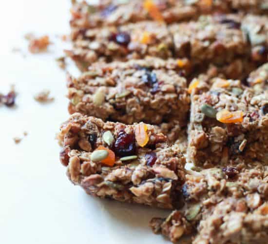 A close-up shot of homemade granola bars arranged on a white countertop