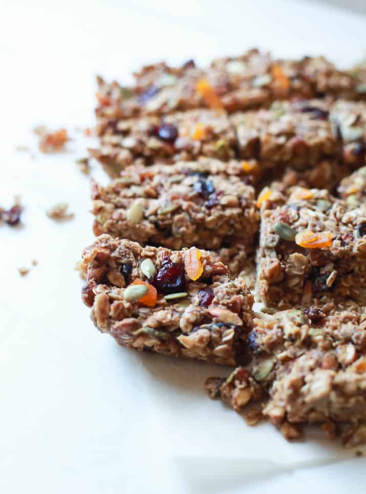 A closeup of homemade granola bars arranged on a white countertop