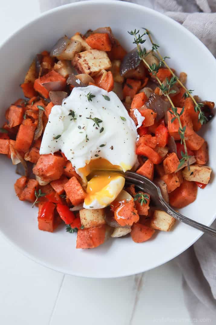 Top view of a bowl of Sweet Potato Hash topped with a Poached Egg