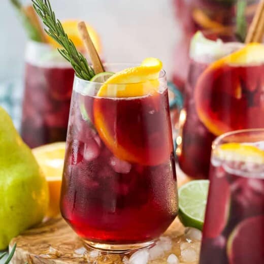 the ultimate holiday sangria recipe in a glass with ice
