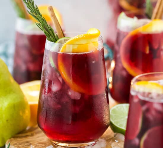 the ultimate holiday sangria recipe in a glass with ice