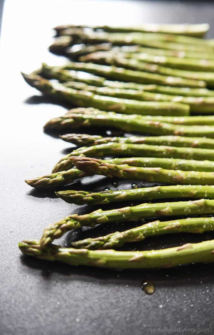 Asparagus spears on a baking sheet