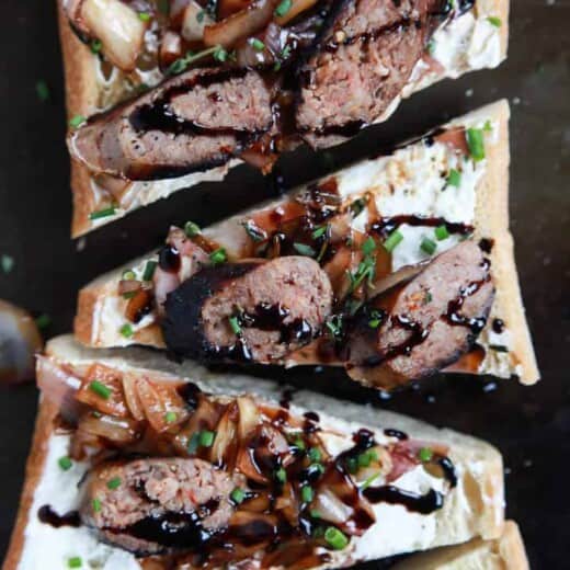 This Balsamic Italian Sausage Crostini is cut into triangles and topped with pan-seared Italian Sausage, whipped Goat Cheese, and balsamic relish | joyfulhealthyeats.com