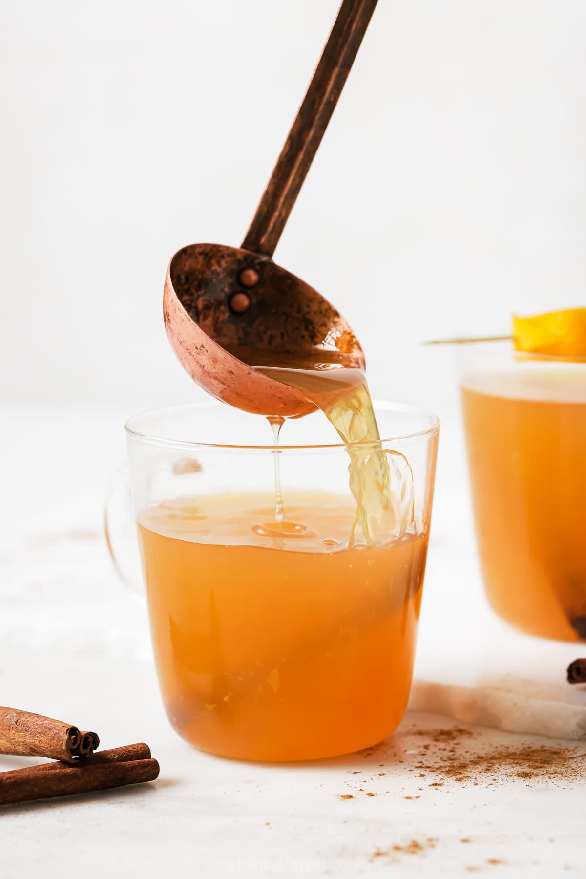 Ladling the apple cider into a serving glass. 