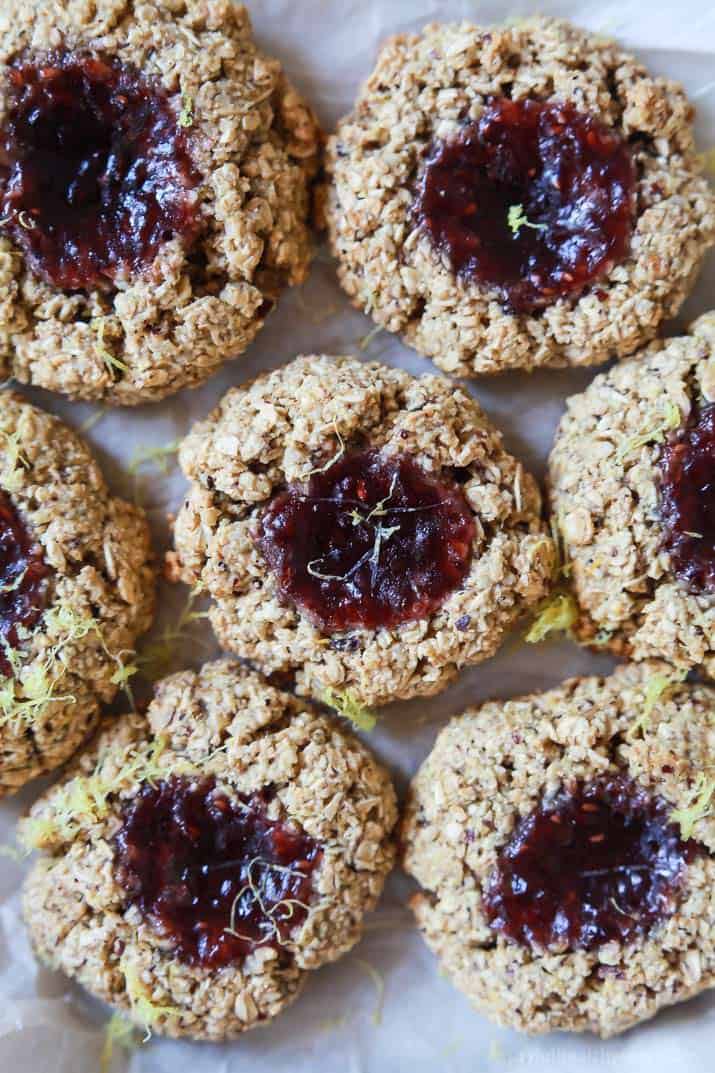 Close-up of Flourless Lemon Raspberry Thumbprint Cookies on parchment