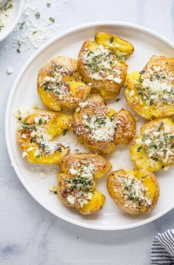 Smashed potatoes with a garlic-herb mixture on top.