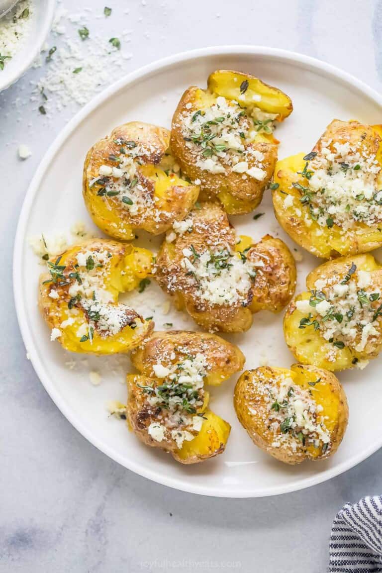 Smashed potatoes with a garlic-herb mixture on top.