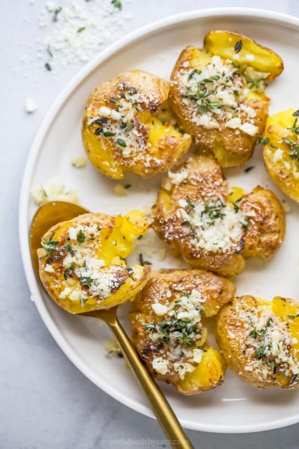 Smashed potatoes with garlic, parmesan, and thyme on top.