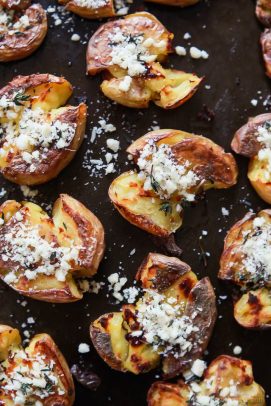 Ten Garlic Herb Smashed Potatoes on a Baking Sheet