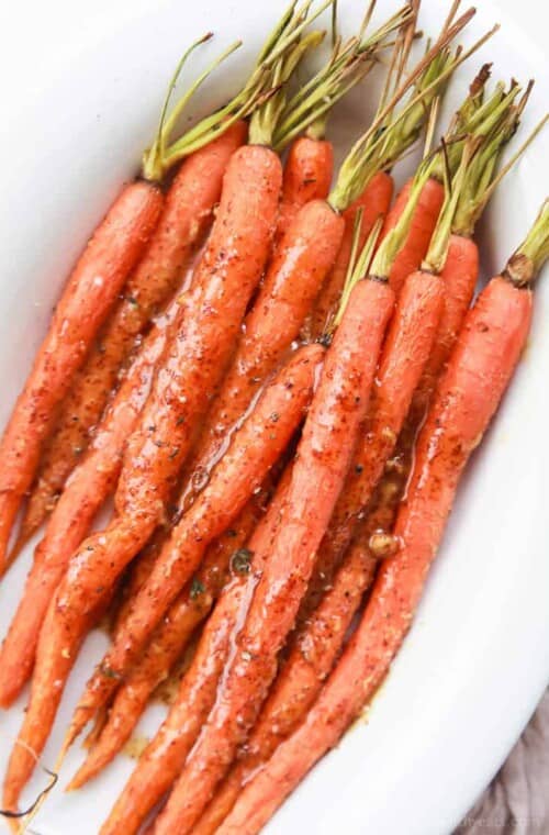 A large white bowl filled with Honey Mustard Glazed Carrots