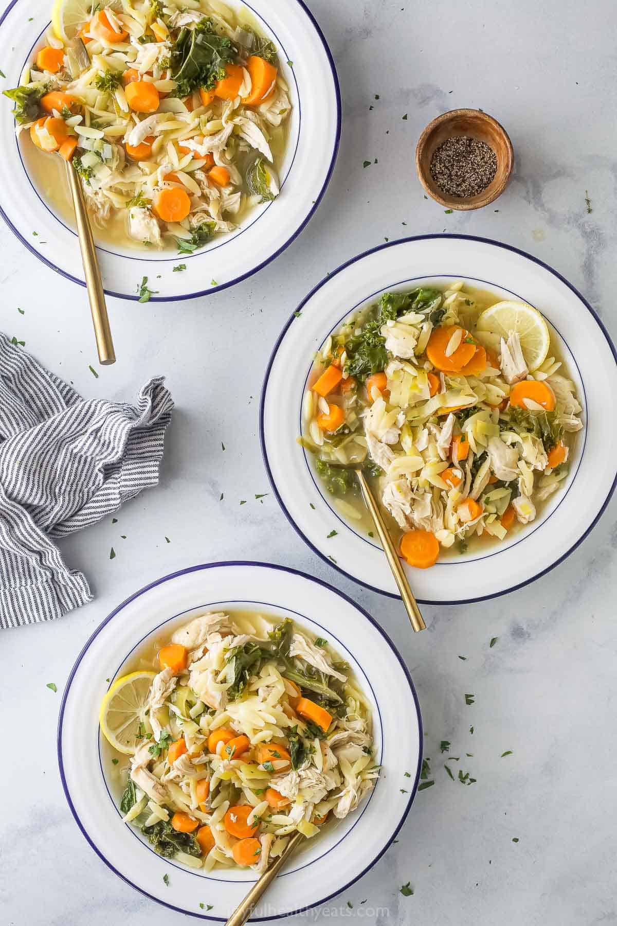 Three bowls of orzo soup. 