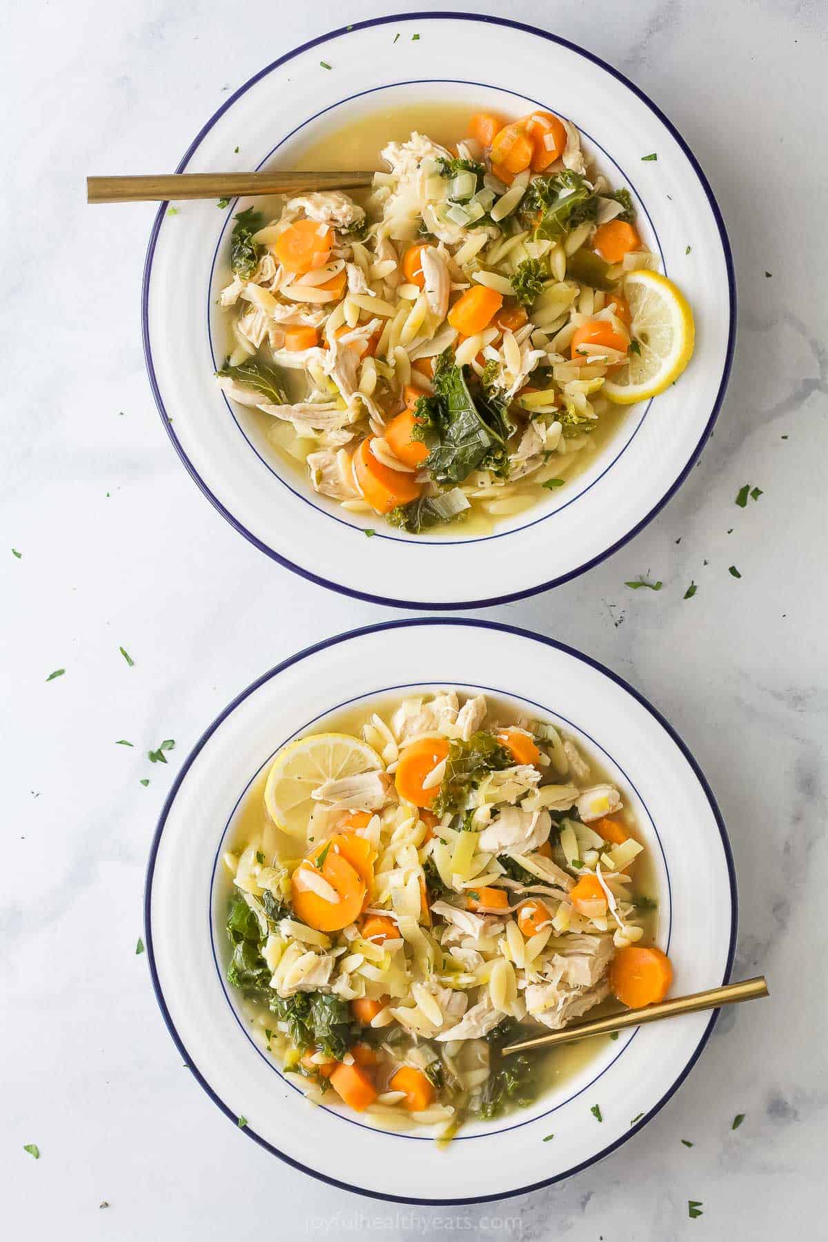 Two bowls of lemon chicken orzo soup.