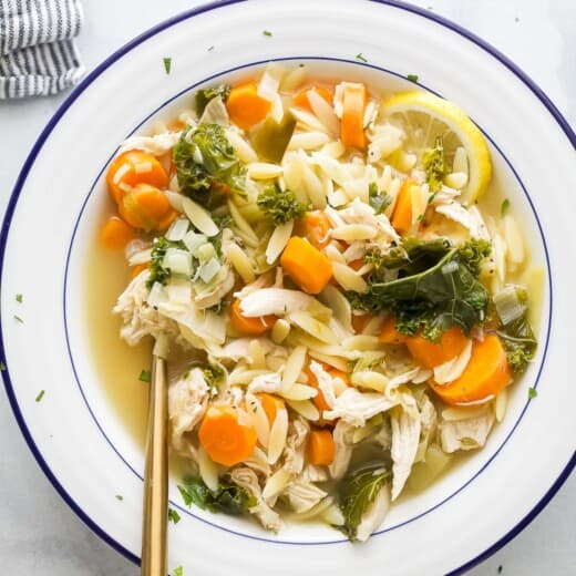 Bowl of lemon chicken orzo soup.