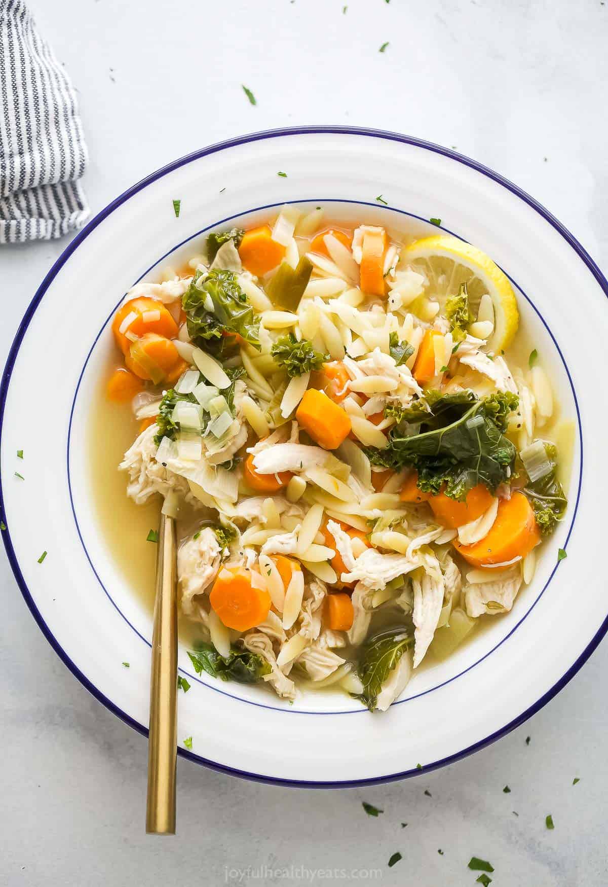 Bowl of lemon chicken orzo soup.