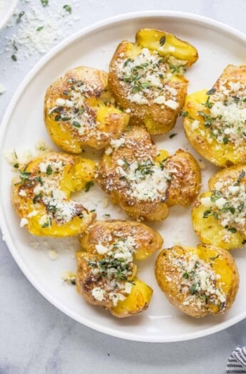 Smashed potatoes with a garlic-herb mixture on top.