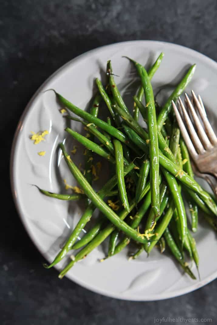 A Pile of Skillet Green Beans with Lemon and Garlic on a White Plate