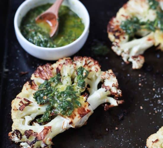 Easy naturally Gluten Free Roasted Cauliflower Steaks topped with fresh zesty Chimichurri Sauce at only 106 calories. Who knew Cauliflower could taste so good! This recipe is down right addicting! | joyfulhealthyeats.com Easy Healthy Recipes