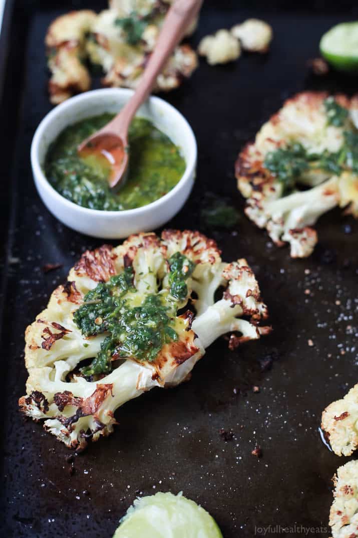 Easy naturally Gluten Free Roasted Cauliflower Steaks topped with fresh zesty Chimichurri Sauce at only 106 calories. Who knew Cauliflower could taste so good! This recipe is down right addicting! | joyfulhealthyeats.com Easy Healthy Recipes