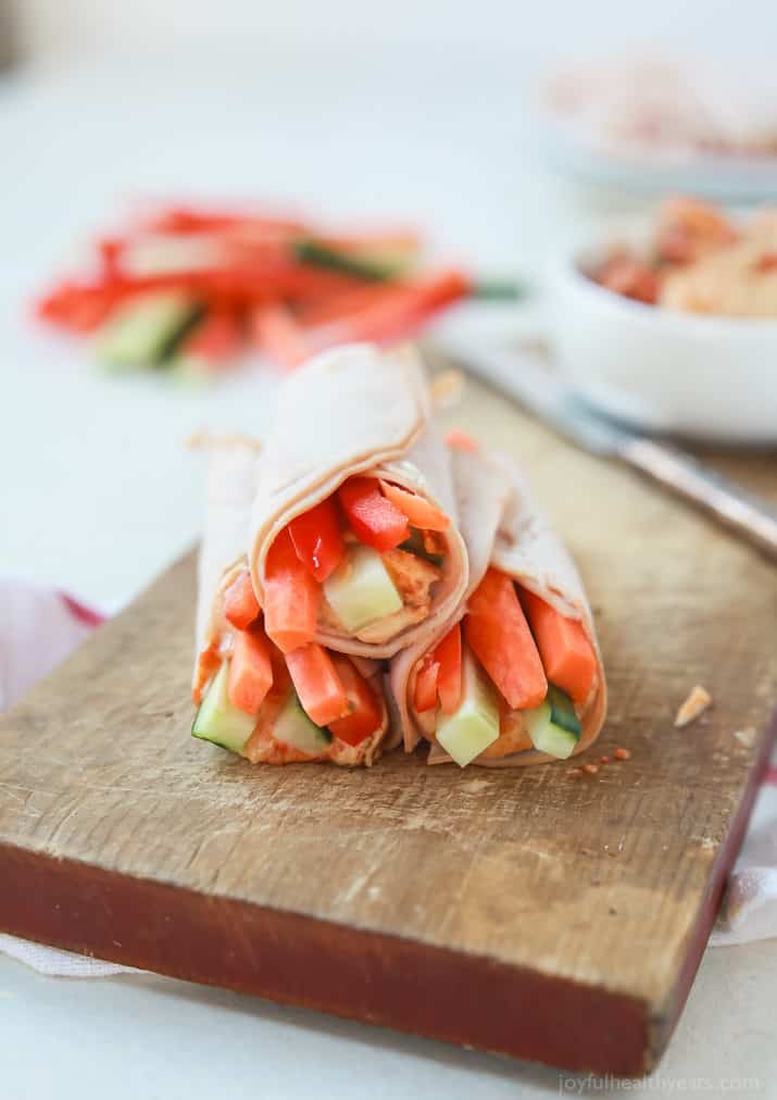 Veggie Turkey Rollups stacked on a wooden board