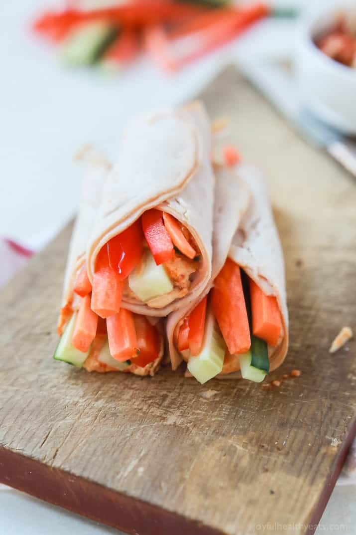 Veggie Turkey Rollups stacked on a wooden board