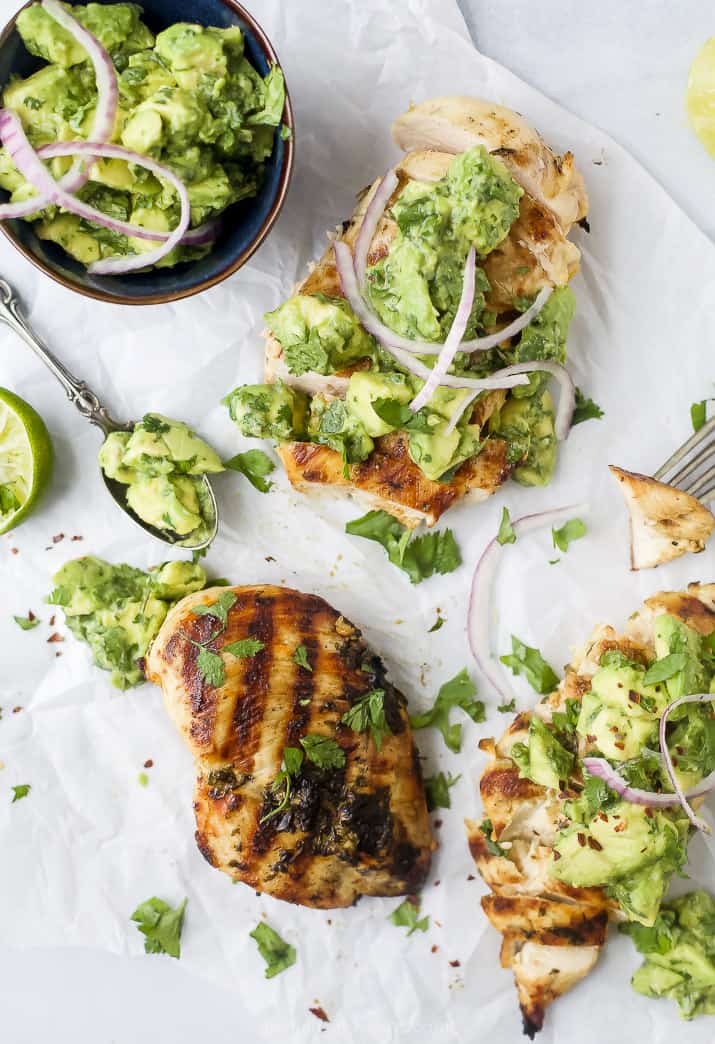 grilled cilantro lime chicken topped with avocado salsa and sliced onions