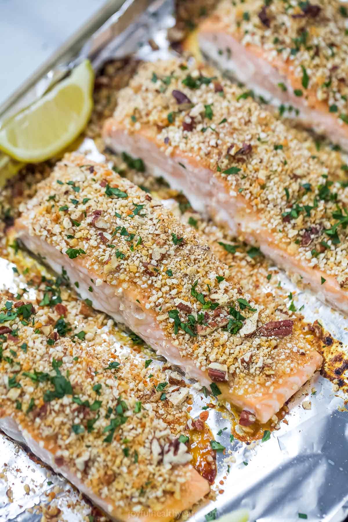 Baked pecan crusted salmon in the baking sheet.