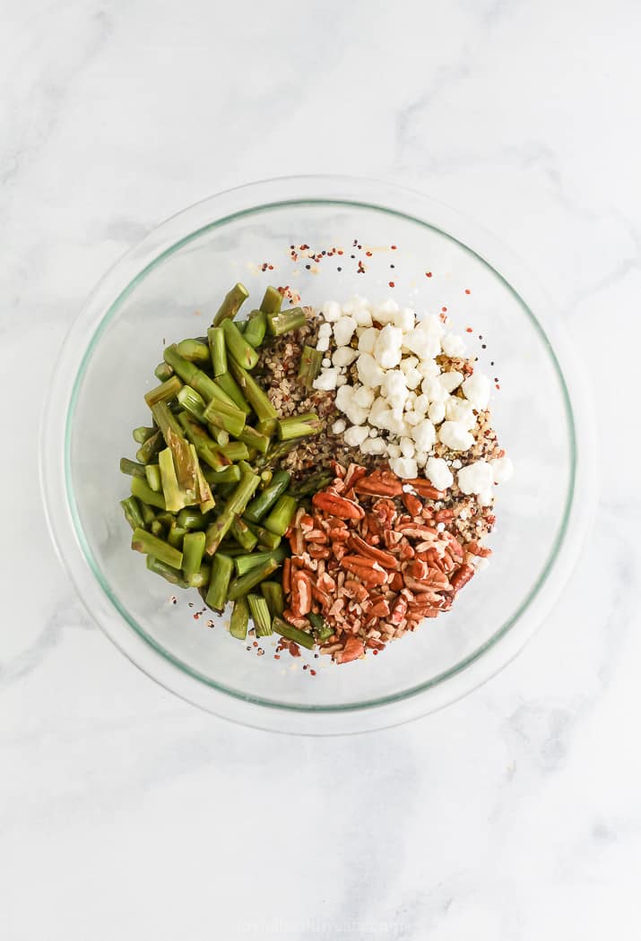 ingredients for light creamy goat cheese asparagus quinoa salad in a glass bowl