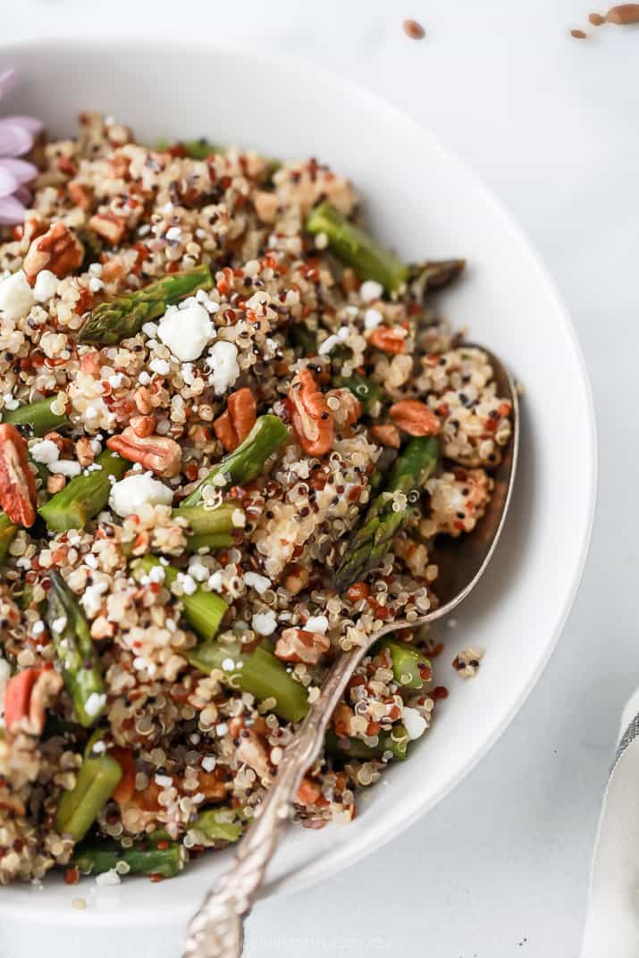 side photo of light creamy goat cheese asparagus quinoa salad in a bowl