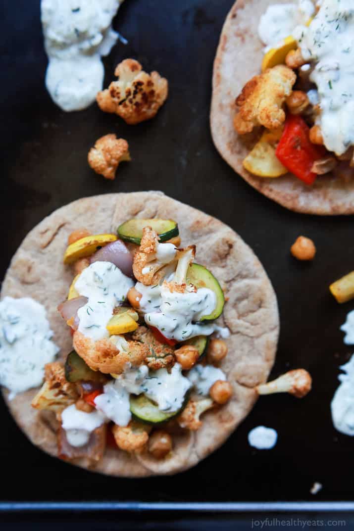 Moroccan Cauliflower Chickpea Pita - done in 35 minutes, filled with spiced roasted vegetables & covered in Tzatziki Sauce. A meal your family will love and perfect for meatless Monday! | joyfulhealthyeats.com #vegetarian
