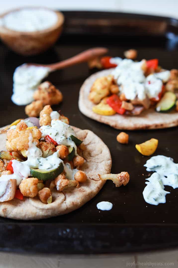 Moroccan Cauliflower Chickpea Pita - done in 35 minutes, filled with spiced roasted vegetables & covered in Tzatziki Sauce. A meal your family will love and perfect for meatless Monday! | joyfulhealthyeats.com #vegetarian