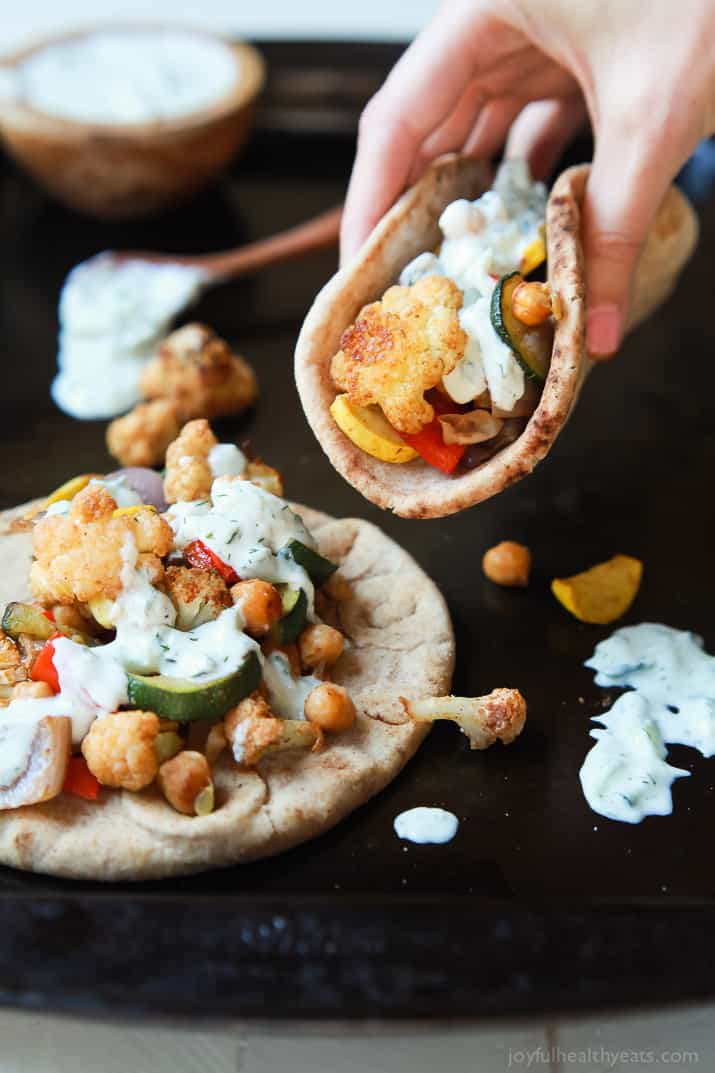 Moroccan Cauliflower Chickpea Pita - done in 35 minutes, filled with spiced roasted vegetables & covered in Tzatziki Sauce. A meal your family will love and perfect for meatless Monday! | joyfulhealthyeats.com #vegetarian