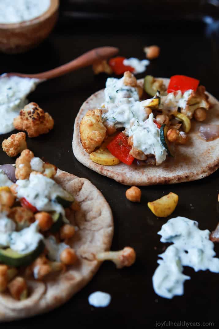 Moroccan Cauliflower Chickpea Pita - done in 35 minutes, filled with spiced roasted vegetables & covered in Tzatziki Sauce. A meal your family will love and perfect for meatless Monday! | joyfulhealthyeats.com #vegetarian