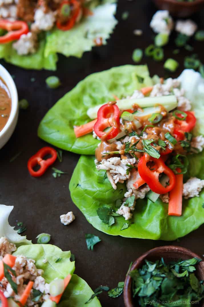 Thai Chicken Lettuce Wraps - made from scratch with chicken, fresh ginger, cilantro, fresh vegetables and slathered with a Spicy Peanut Sauce. This quick easy recipe is ready in just 20 minutes and to die for! | joyfulhealthyeats.com #glutenfree