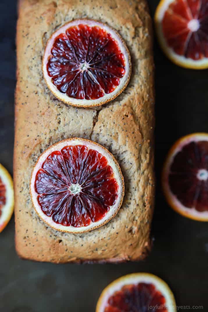 Top view of a loaf of Blood Orange Poppy Seed Bread with slices of blood orange on top