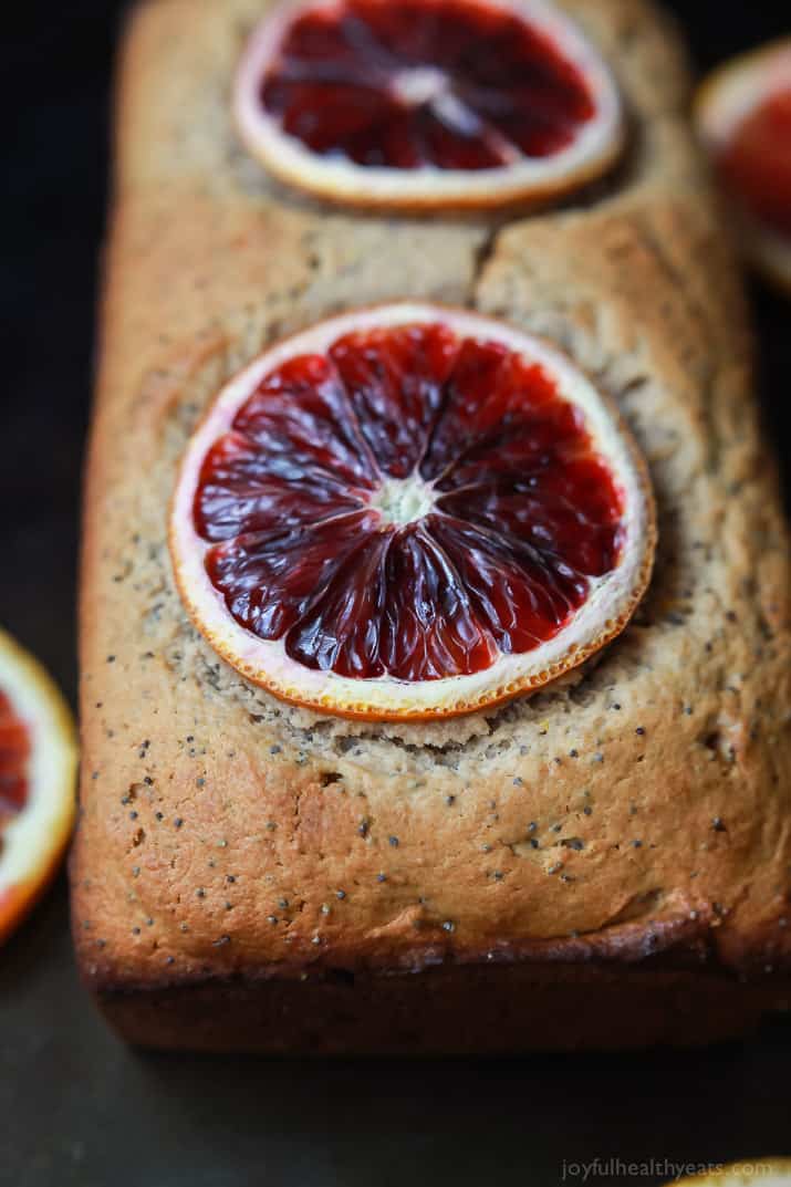 A loaf of Blood Orange Poppy Seed Bread with two slices of blood orange on top