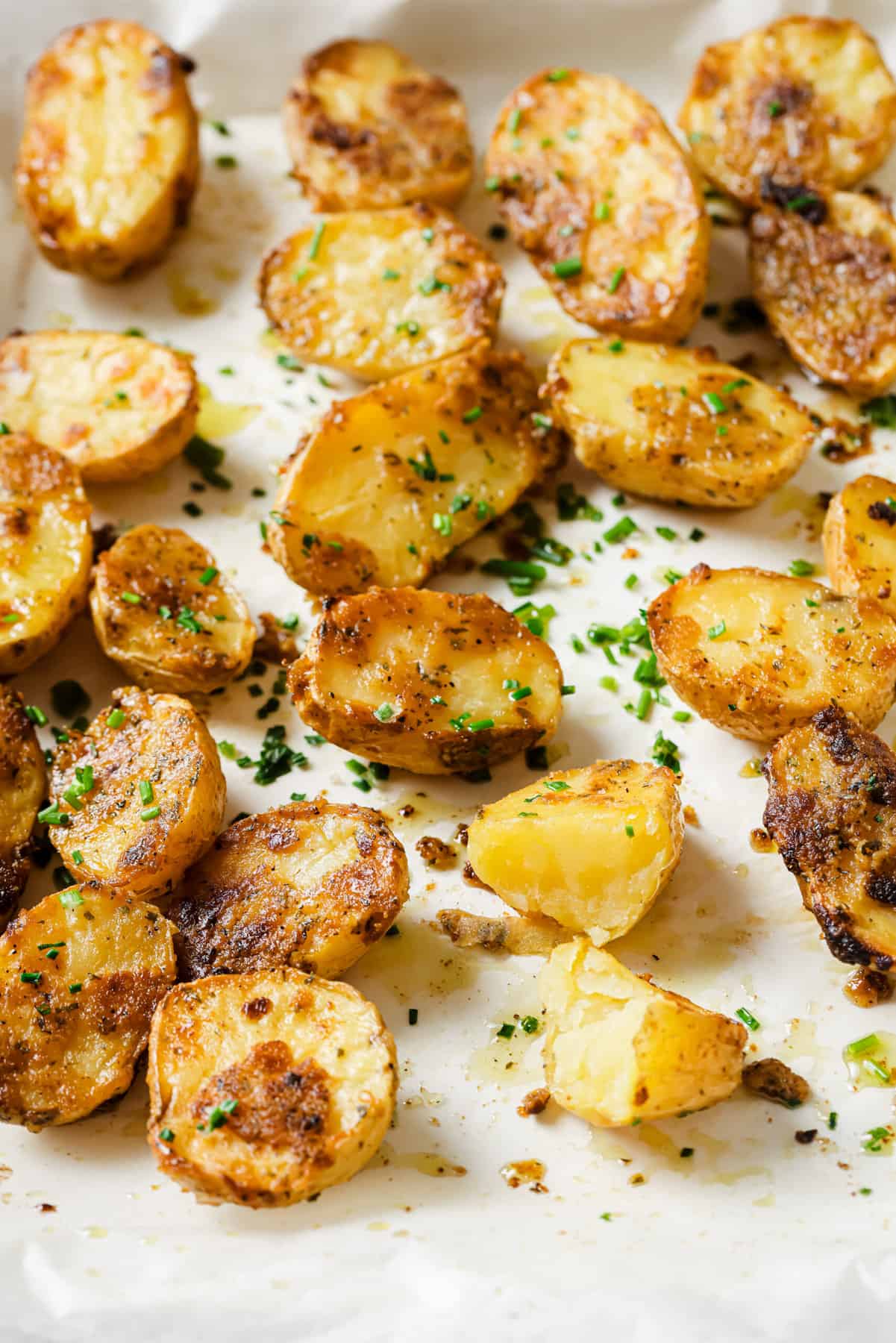 These garlic ranch potatoes are an easy baked side that'll make everyone happy with their crispy exterior and buttery center. Garlic ranch potatoes in the baking tray.