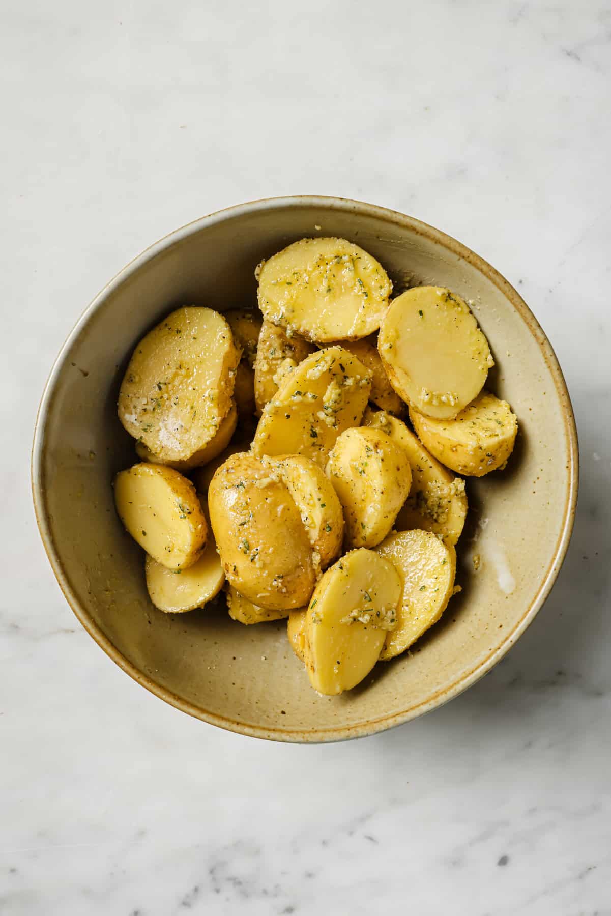 These garlic ranch potatoes are an easy baked side that'll make everyone happy with their crispy exterior and buttery center. Tossing the potatoes in the ranch mixture.