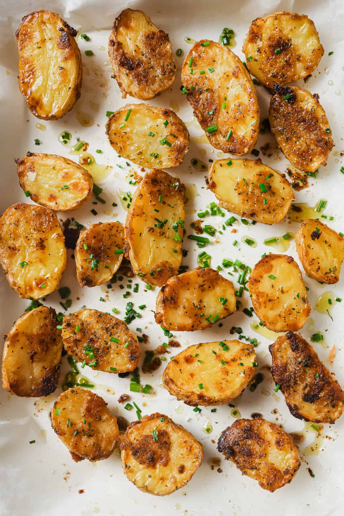 Garlic ranch potatoes in the baking tray sprinkled with parsley. 