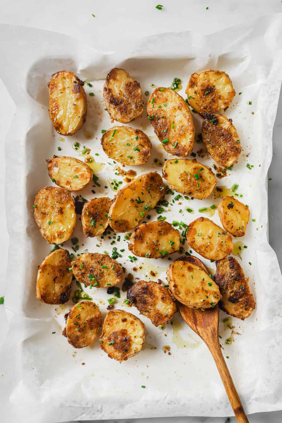 These garlic ranch potatoes are an easy baked side that'll make everyone happy with their crispy exterior and buttery center. Baked garlic ranch potatoes in the baking tray.