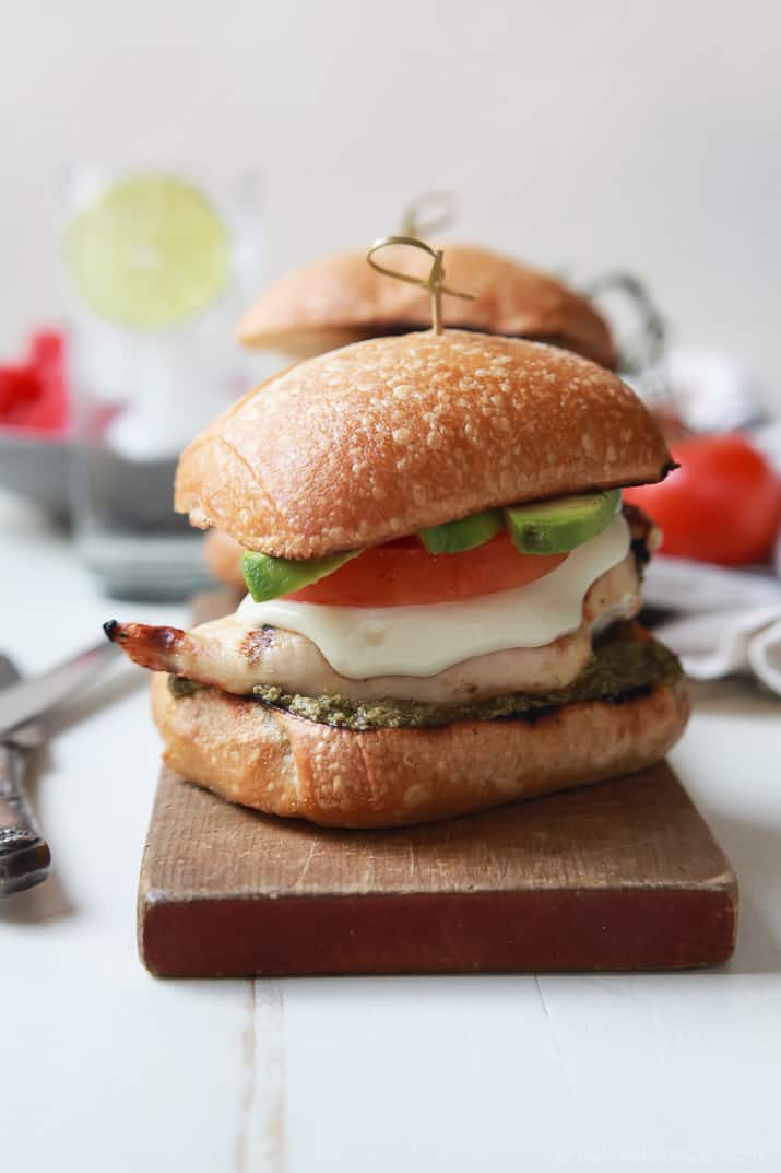 Close-up of Grilled Avocado Caprese Chicken Sandwich on a wooden board
