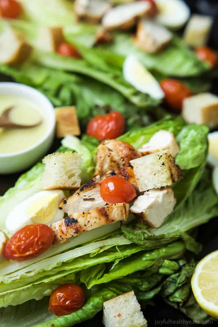 Close-up view of Grilled Chicken Caesar Salad on whole romaine leaves