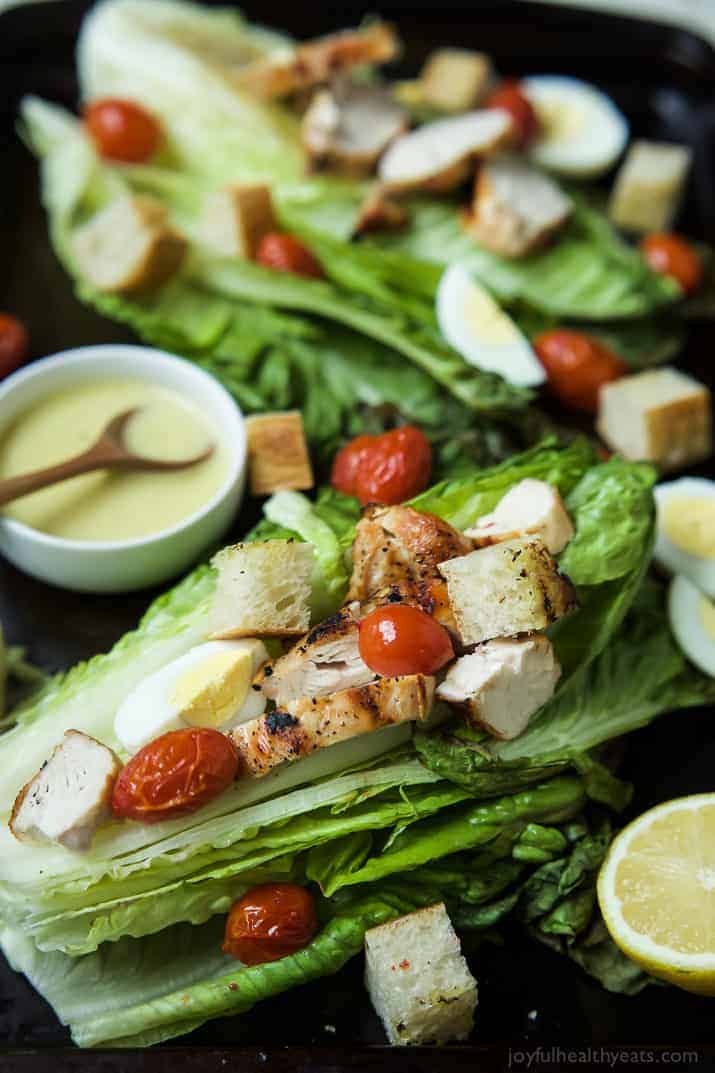 Close-up view of Grilled Chicken Caesar Salad on whole romaine leaves