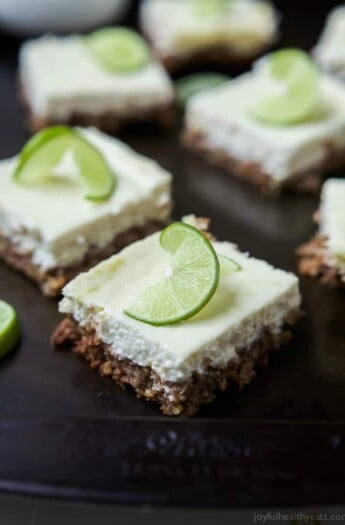 A few Easy Key Lime Cheesecake Bars made lighter with Greek yogurt and a delicious cinnamon pecan crust. This simple dessert is pure cheesecake perfection and guaranteed to win over the hearts of many! | joyfulhealthyeats.com