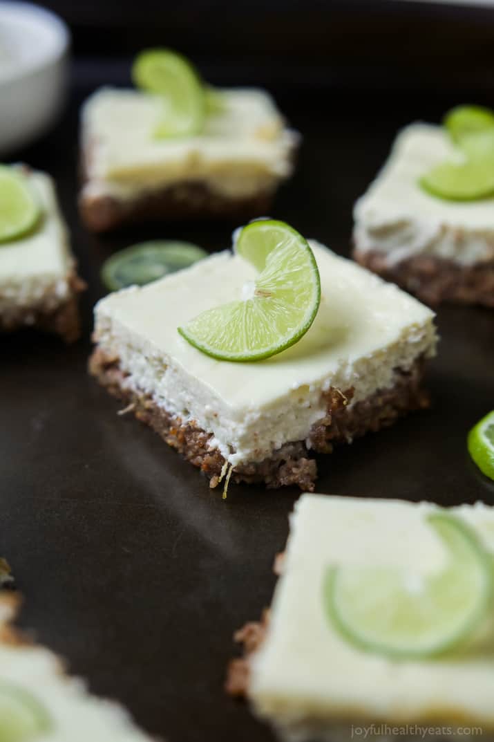 Easy Key Lime Cheesecake Bars made lighter with Greek yogurt and a delicious cinnamon pecan crust. This simple dessert is pure cheesecake perfection and guaranteed to win over the hearts of many! | joyfulhealthyeats.com