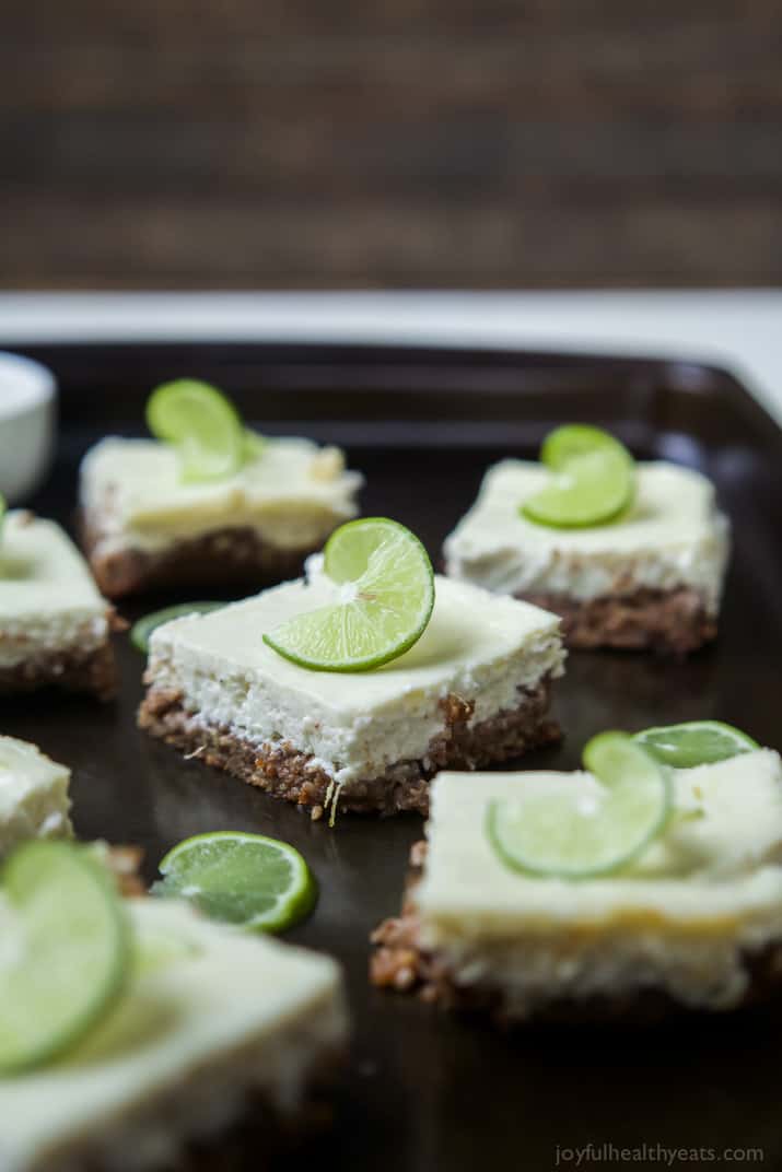 Easy Key Lime Cheesecake Bars made lighter with Greek yogurt and a delicious cinnamon pecan crust. This simple dessert is pure cheesecake perfection and guaranteed to win over the hearts of many! | joyfulhealthyeats.com