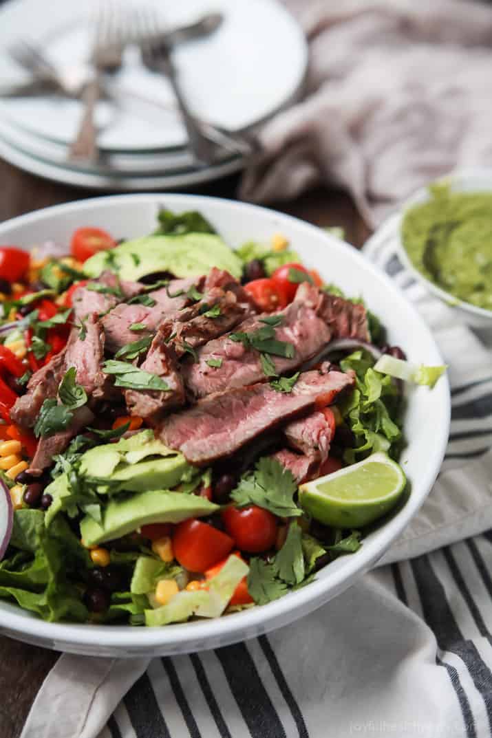 An easy healthy Southwestern Steak Salad loaded with vegetables, tender Ribeye Steak and then topped with a homemade Cilantro Avocado Dressing! Done in 15 minutes, low on calories and rivals any restaurant salad! | joyfulhealthyeats.com #glutenfree